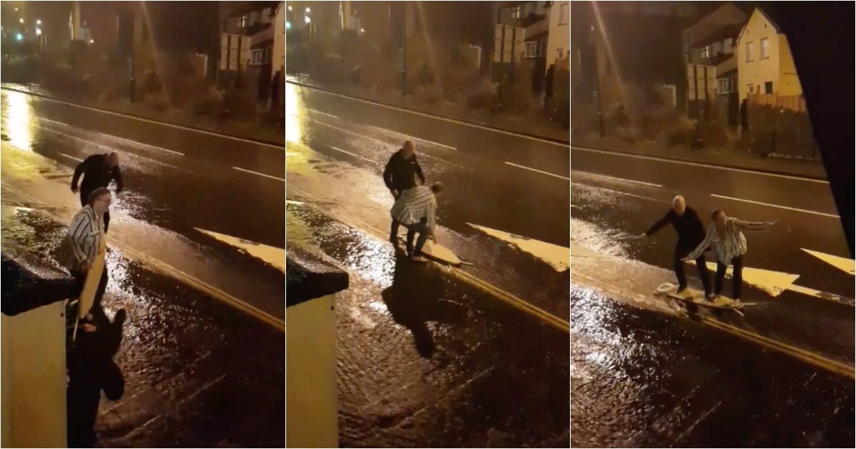 Casal faz surf na rua com tábua de engomar durante tempestade